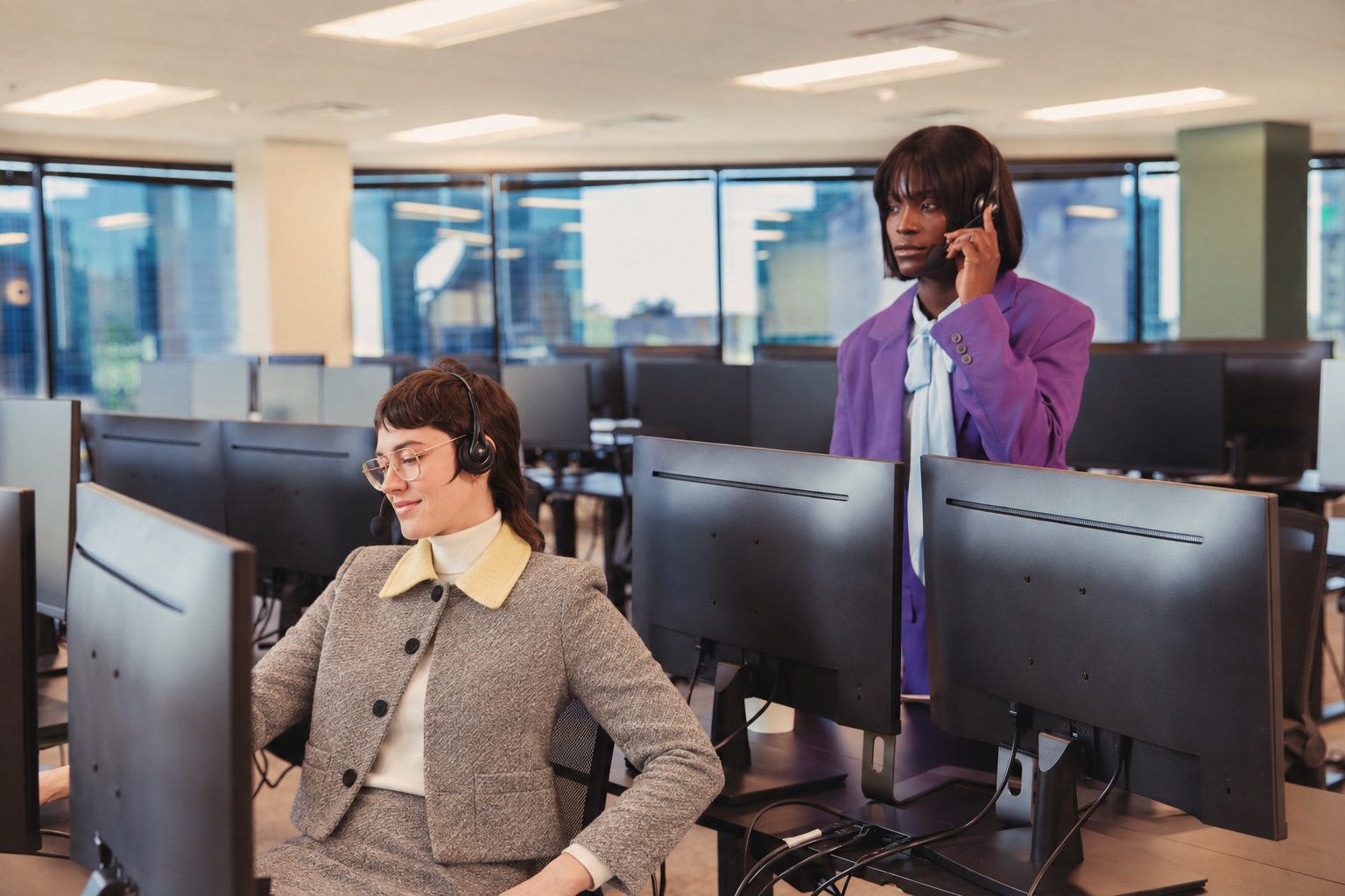 Customer support team working at a bank of office monitors
